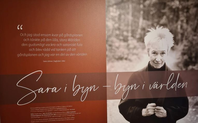 Skylt med texten Sara i byn - byn i världen